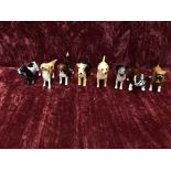 Eight small Beswick dogs.