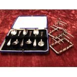 A pair of George VI silver toast racks and a boxed set of six silver teaspoons.