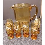 A large amber coloured glass jug with six glasses.