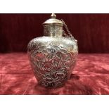 Chinese embossed white metal lidded vase.