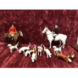 A Beswick hunting scenes to include seven fox hounds, two foxes, one huntsman and one huntswoman.
