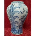 A large 19th Century Chinese octagonal shaped blue and white vase depicting cloud dragons.