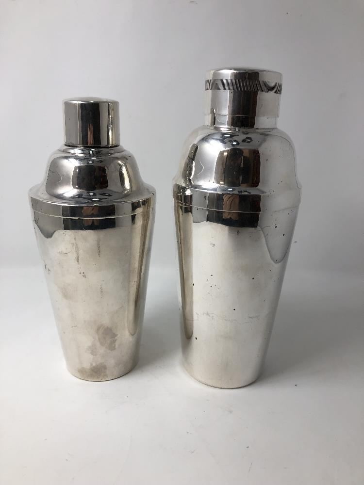 Two silver plated cocktail shakers.