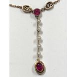 A 9ct gold Art Deco style necklace with a gold pendant of five pearls and ruby.