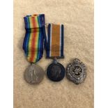 A WW1 medal pair with his original cap badge.