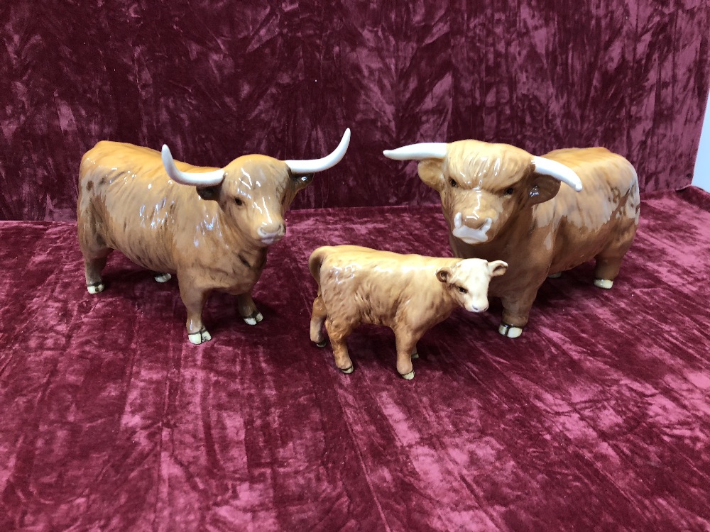 A Beswick Highland bull, cow and calf.