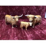 A Beswick Highland bull, cow and calf.