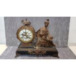 A 19th Century spelter eight day clock with an American movement and enamel dial.