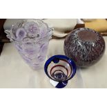 A collection of purple and blue studio art glass vases.