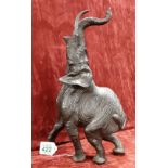 A cast bronze figure of a rearing elephant. 39cm tall