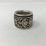 A Chinese white metal thumb ring with inner revolving ring.