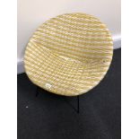 A 1960s retro woven plastic tub chair in yellow and white.