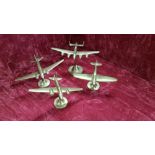 Four brass World War 2 aeroplanes on brass stands.