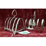 A pair of silver toast racks.