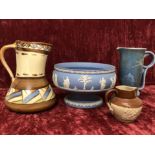 Three assorted ceramic jugs and a Wedgwood pedestal fruit bowl.