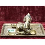 A brass figure of the Indian deity Ganesha and a brass card tray.