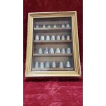 A case of 25 thimbles including 19 silver.