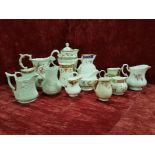 A collection of thirteen china jugs.