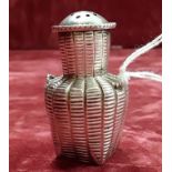 A small silver pepper shaker in the form of a wicker basket
