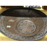 A large copper Alque Kapsa serving dish from Saudi Arabia copper and a plated wall hanging plate.