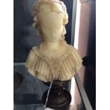 A wax bust of an 18th Century lady on a wooden pedestal base. Signed.