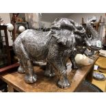 A silvered resin figure of a mature elephant 49cm tall.