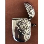 An oval shaped silver vesta case with engraved decoration.
