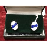 A boxed pair of silver cufflinks.