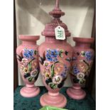 A Victorian pink opaline garniture set painted with floral panels.