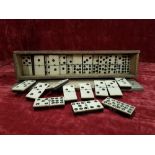 A complete set of late 19th Century/early 20th Century bone and ebony nine dot dominoes.