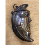 A brass vesta case in the form of a half moon.