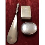 An Egyptian silver matchbox holder, silver shoehorn and silver trinket box.