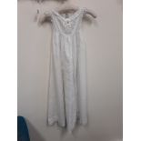 A white fine cotton long christening gown.