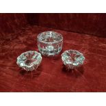 A collection of three Costa Boda Swedish glass candlesticks, all signed to bases.