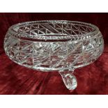 A large gut glass bowl raised on three supports.