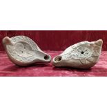 Two clay reproduction decorative Roman oil lamps.
