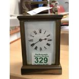 A brass carriage clock in working order.