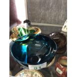 A Langhan glass paperweight in the form of an otter, a Murano glass bowl and a green glass bowl.
