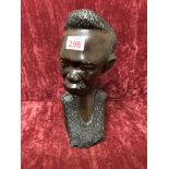 A large wooden carved bust of an African man.