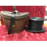 A vintage Christie's silk top hat with leather case.
