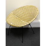 A 1960s retro woven plastic tub chair in yellow and white.