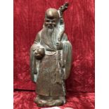 A Japanese bronze statue in the form of a Japanese scholar in traditional robes.