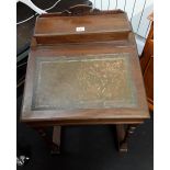 An late Victorian oak davenport desk with rising lid