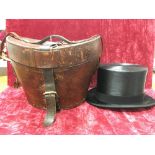 A silk racing top hat size 7 1/8, with a purple silk lined leather case.