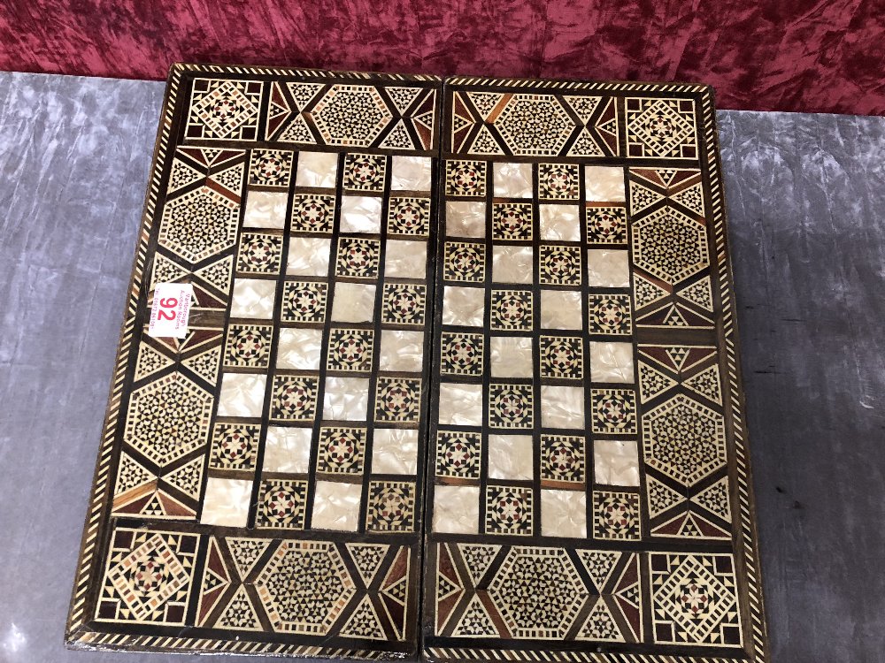 A chess and backgammon box with inlay of mother of pearl and painted ivory squares.