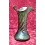 An iridescent ribbed vase in the Loetz style.