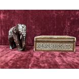 A lidded box inlaid with mother of pearl together with an ornate elephant with inlaid decoration.