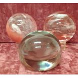 Two spherical glass paperweight of unusual design, plus one other.