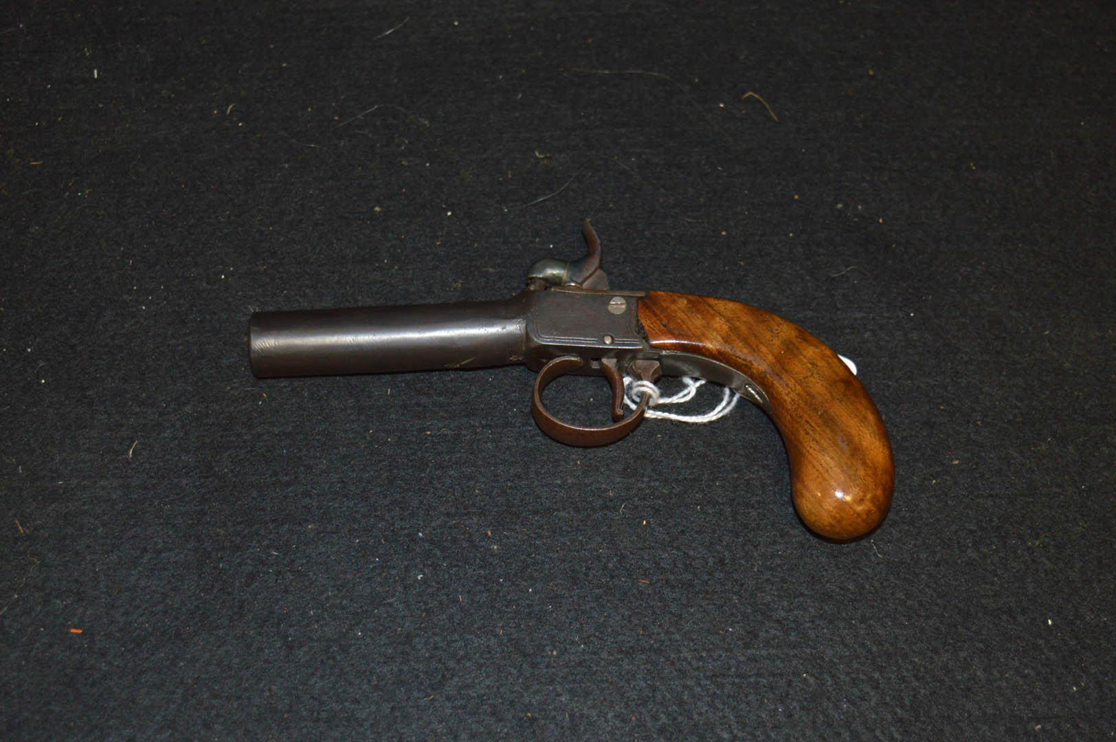 A Small Wooden Handled Small Pistol