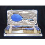 A Very Nice Cased Silver and Blue Enamel Dressing Set, London 1939,